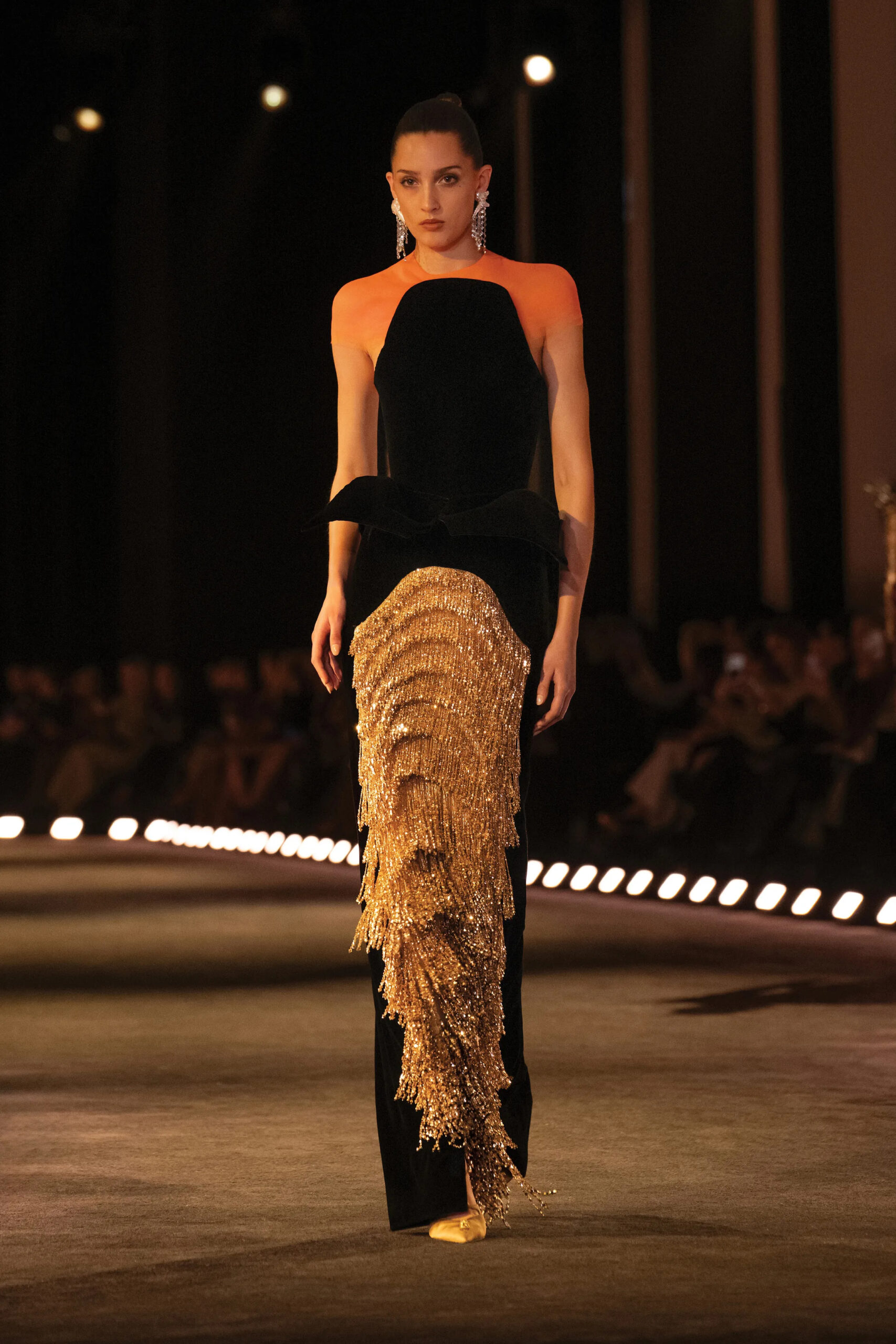 Black Schiaparelli couture column gown with asymmetrical gold crystal fringe detail