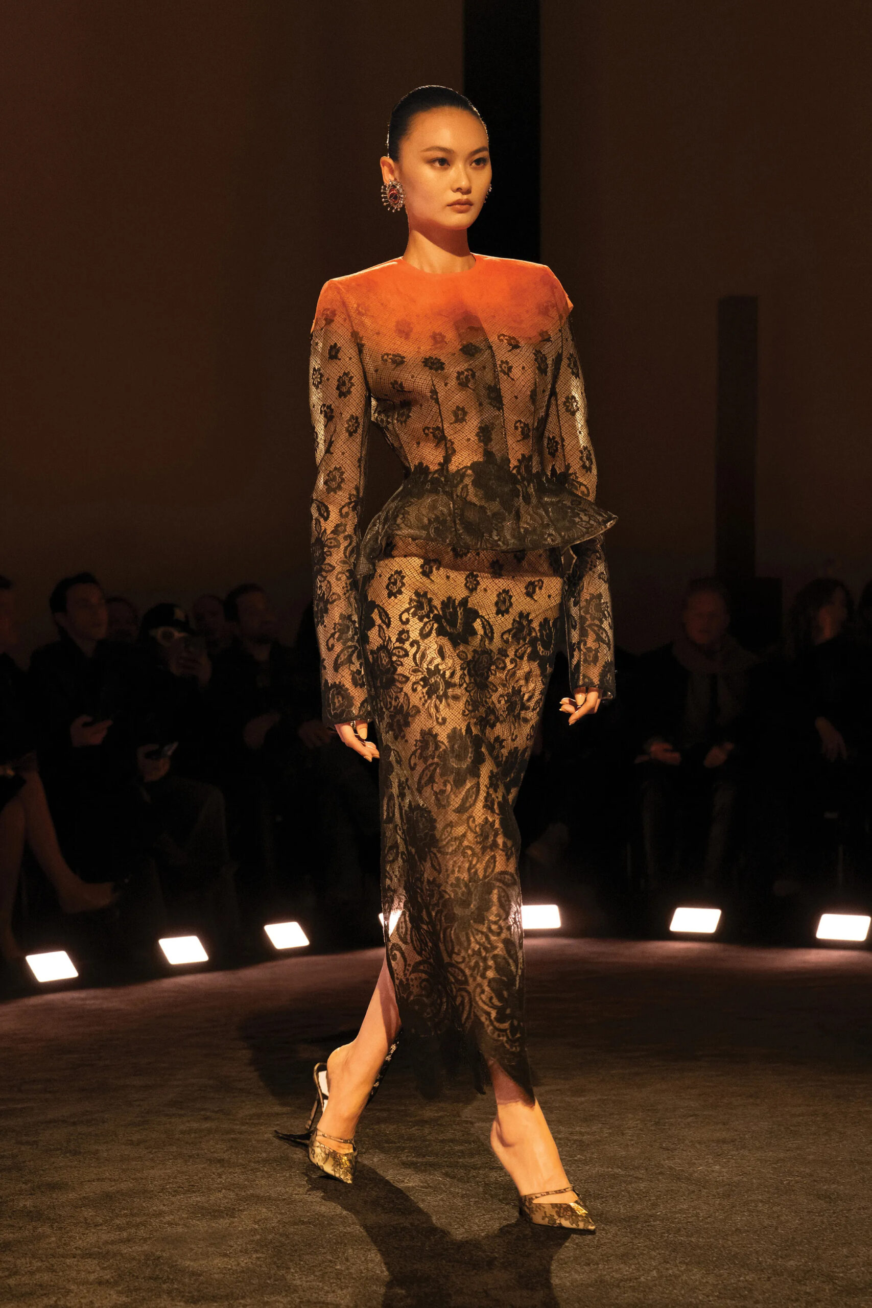 Black lace Schiaparelli couture gown with structured silhouette and sheer detailing