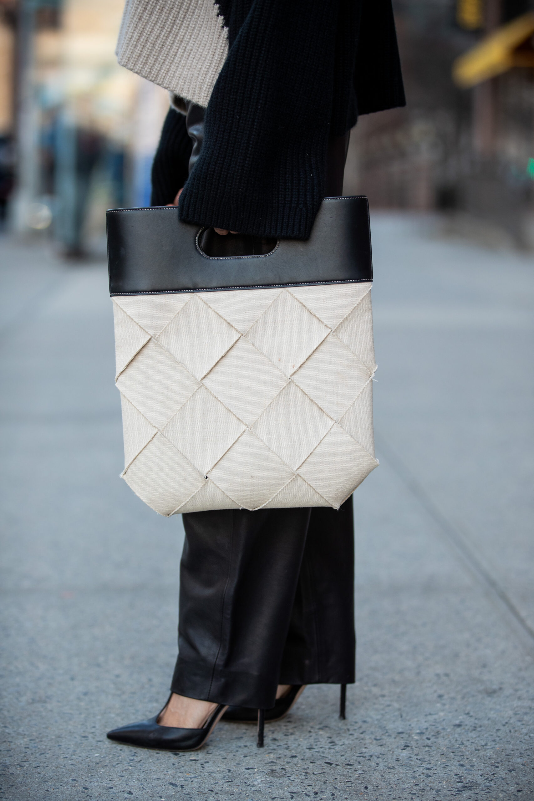 Bottega Veneta woven tote paired with KHAITE leather trousers and Gianvito Rossi heels.