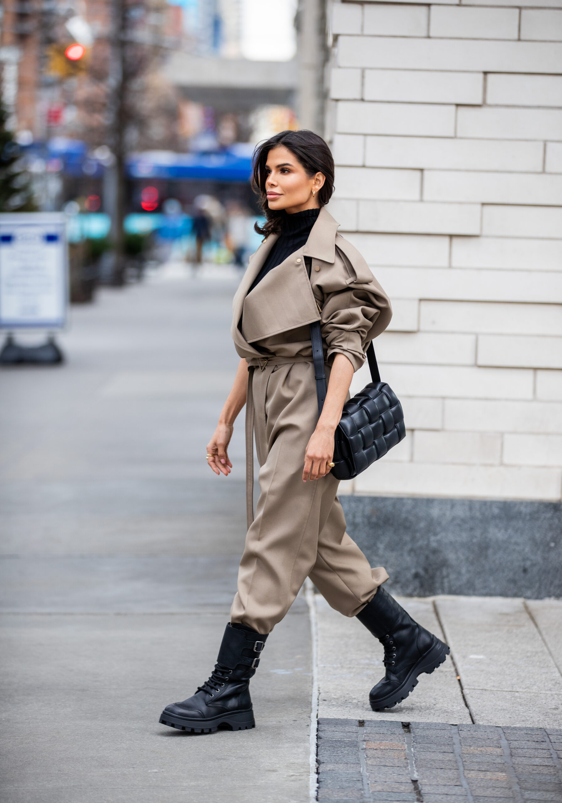 Side profile of Victoria Barbara wearing a Bottega Veneta utility jumpsuit styled with a woven Bottega Veneta bag.