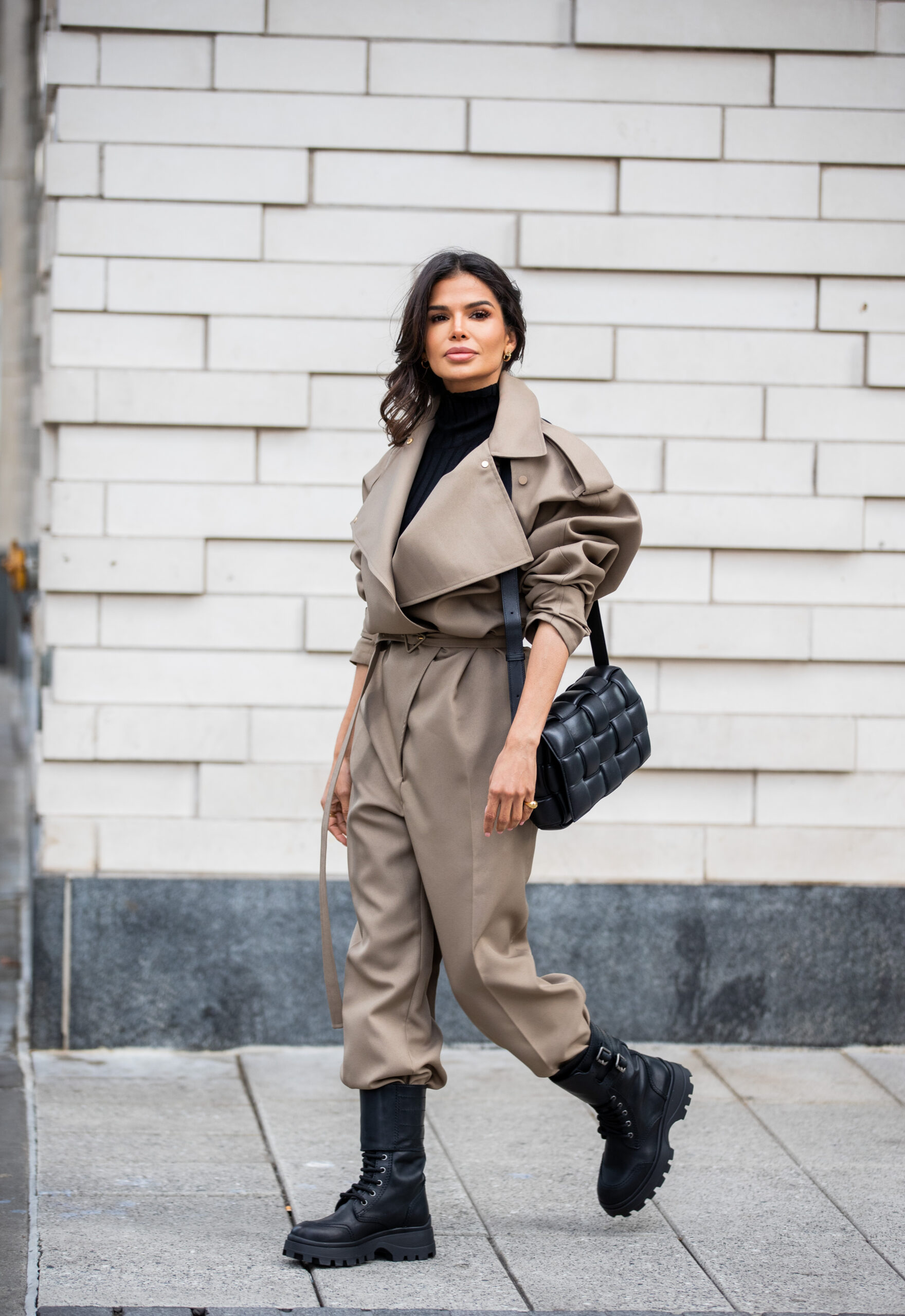Victoria Barbara wearing a taupe Bottega Veneta utility jumpsuit with Miu Miu combat boots while attending New York Fashion Week.