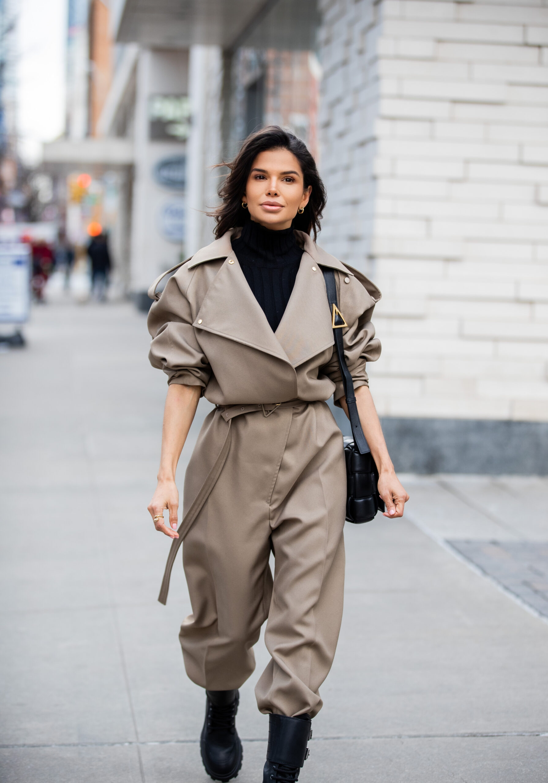 Victoria Barbara walking through New York City in a Bottega Veneta utility jumpsuit and black Miu Miu combat boots.