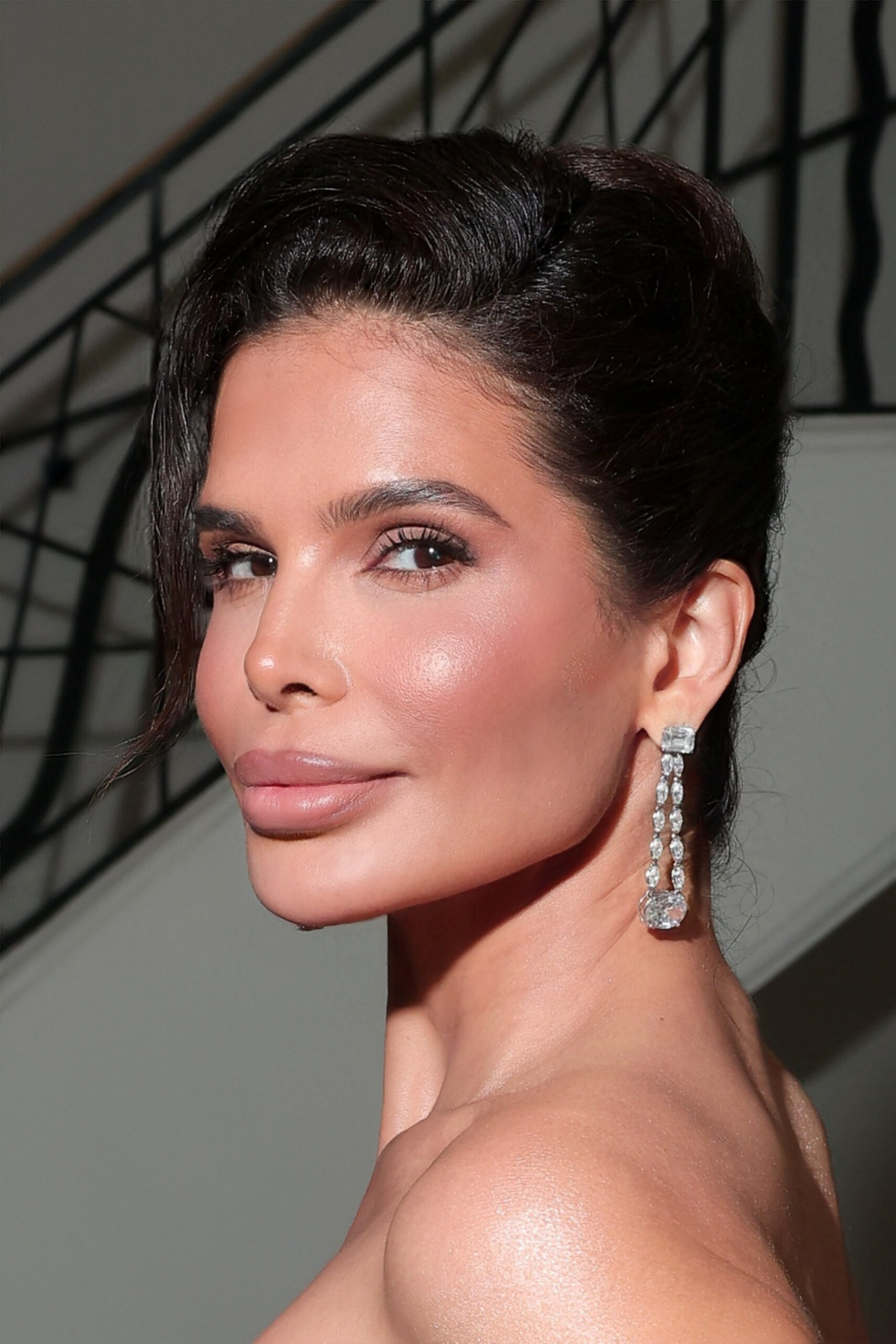 Close-up profile portrait of Victoria Barbara wearing Hassanzadeh diamond earrings at Cannes