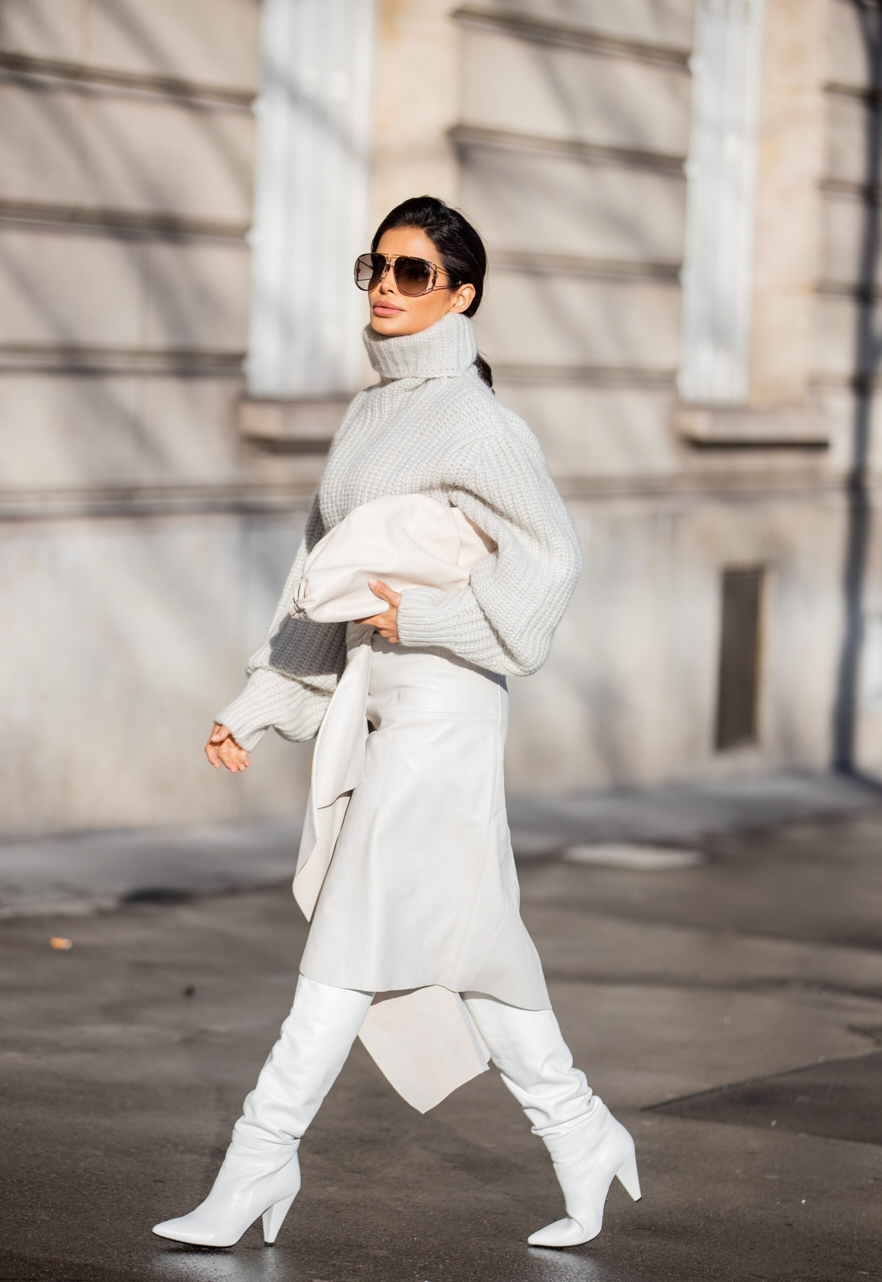Side profile of Victoria Barbara wearing Isabel Marant and carrying a Bottega Veneta clutch in Paris.