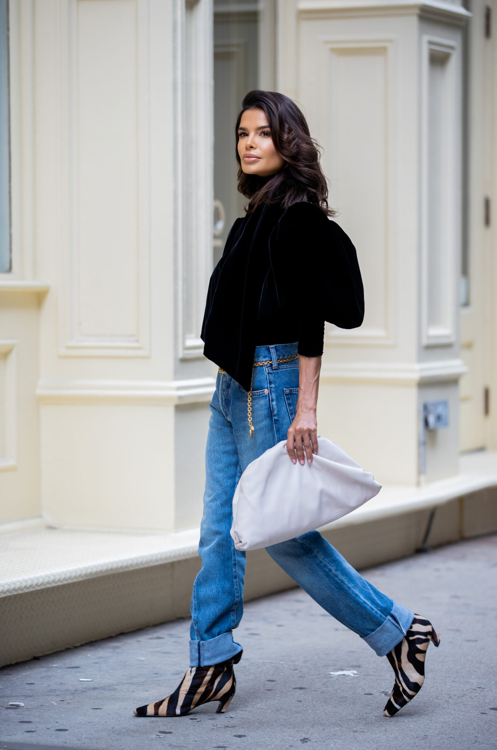 Side profile of Victoria Barbara walking during New York Fashion Week wearing KHAITE, Balenciaga, Chanel and Bottega Veneta.