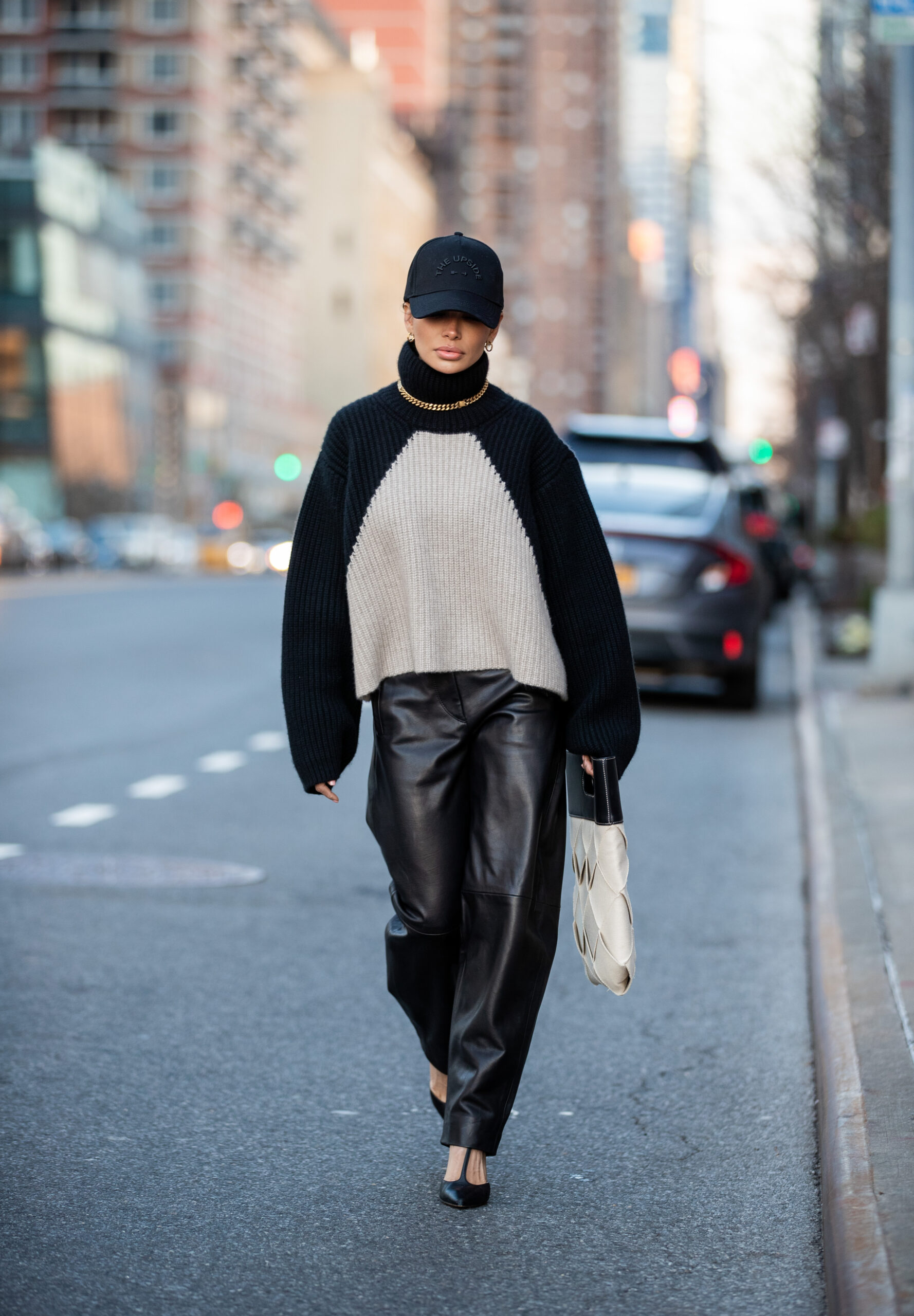 Victoria Barbara styling KHAITE knitwear and leather trousers during a New York street style moment.