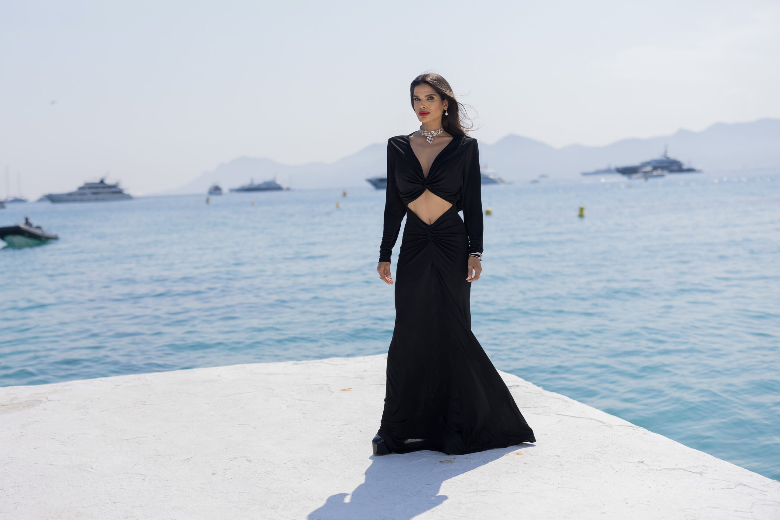 Victoria Barbara wearing Saint Laurent on an ocean platform beside the Mediterranean during the Cannes Film Festival