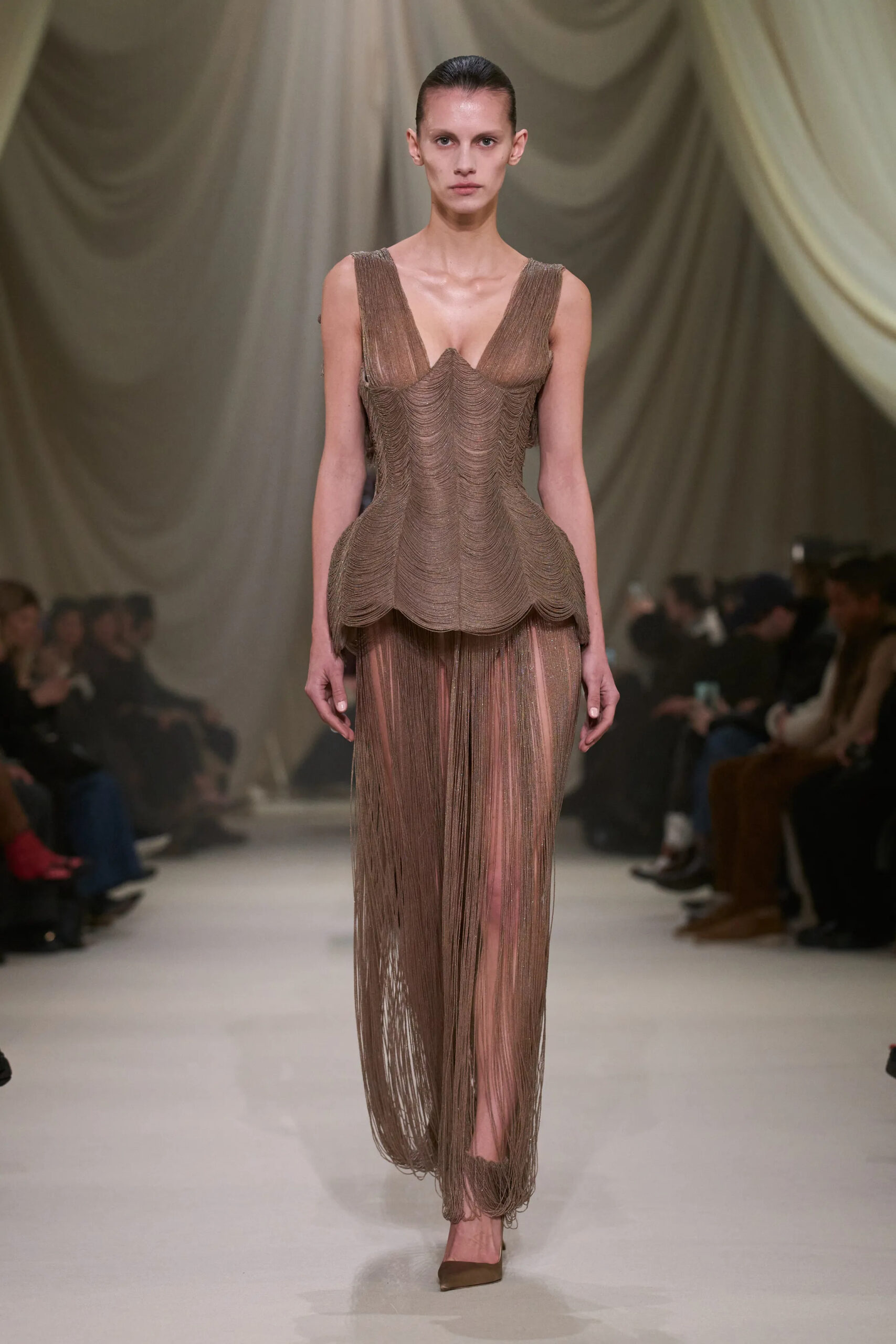 Ashi Studio Spring 2026 Couture bronze chainmail-inspired gown with sculpted bodice and sheer fringe skirt.