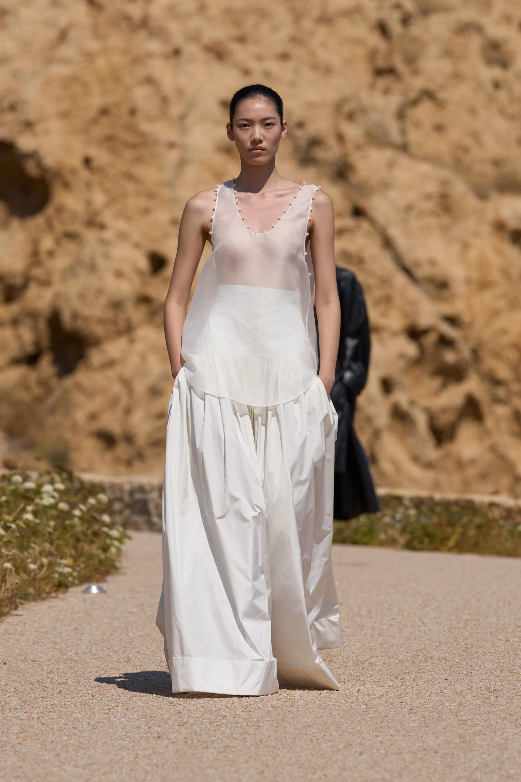 Opening look from Jacquemus Spring Summer 2027 featuring a chartreuse silk sleeveless dress with gathered balloon hem.