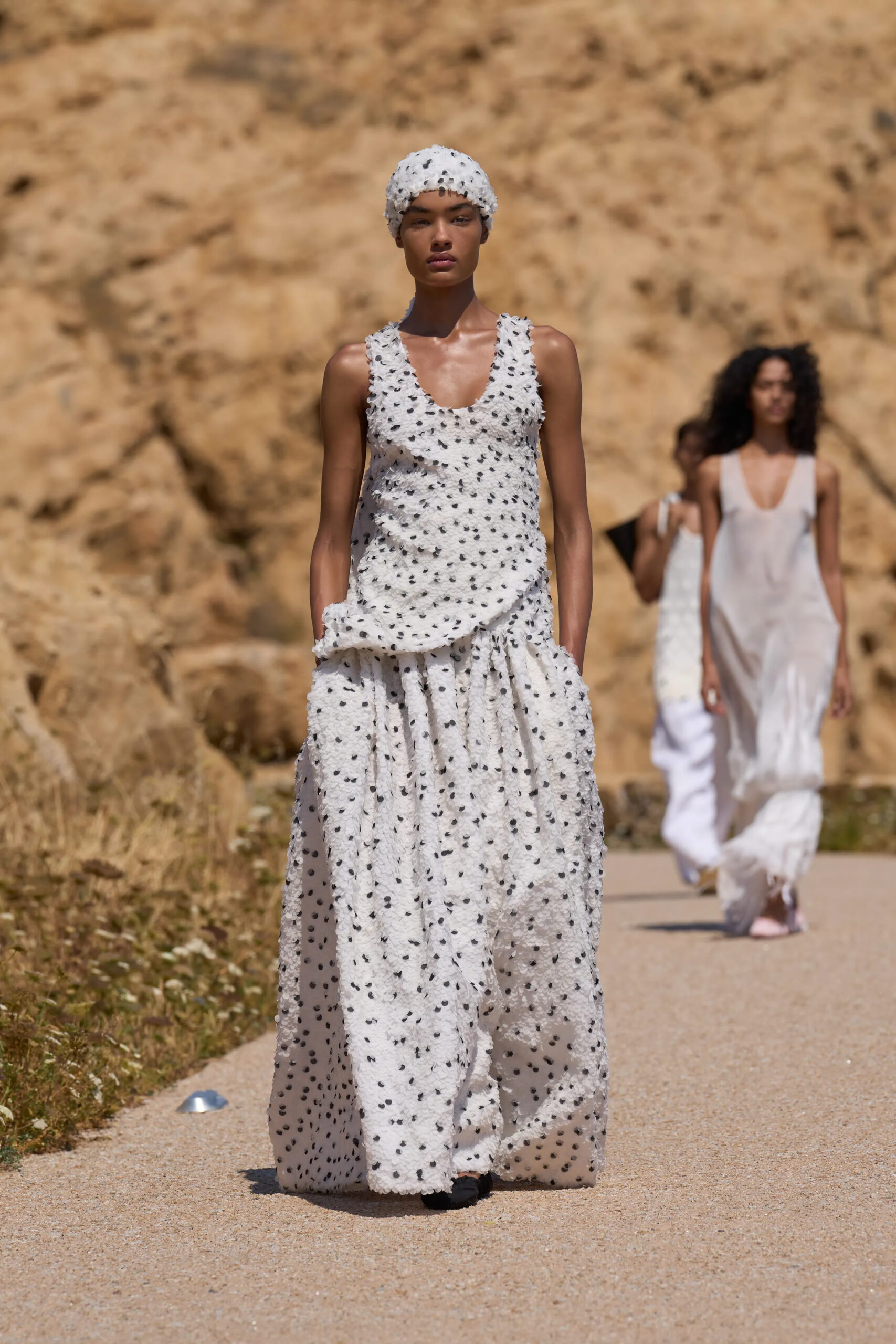 Jacquemus Spring Summer 2027 ivory textured sleeveless top with coordinating voluminous skirt and matching cap.
