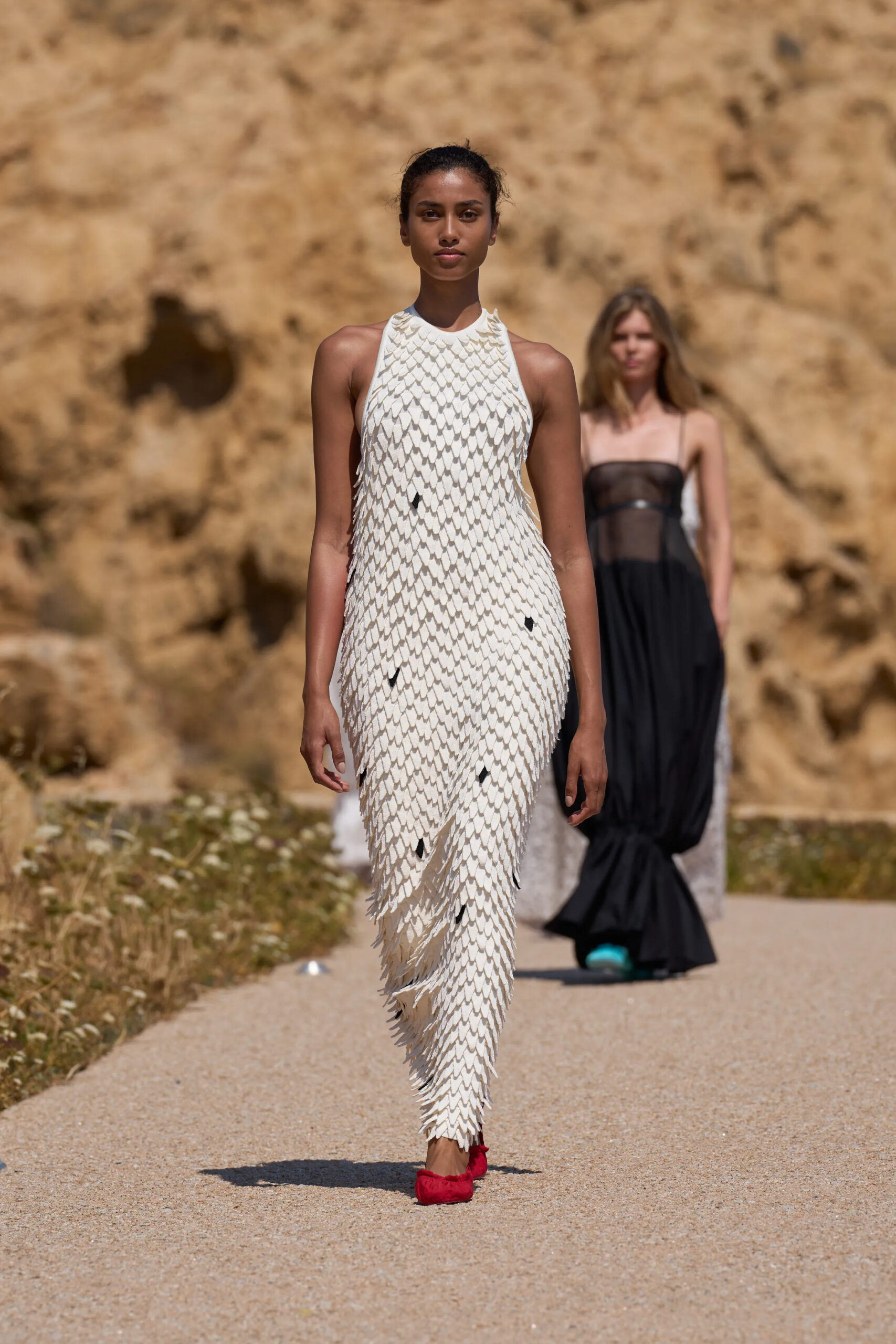 Jacquemus Spring Summer 2027 ivory halter dress with feather-inspired layered detailing.