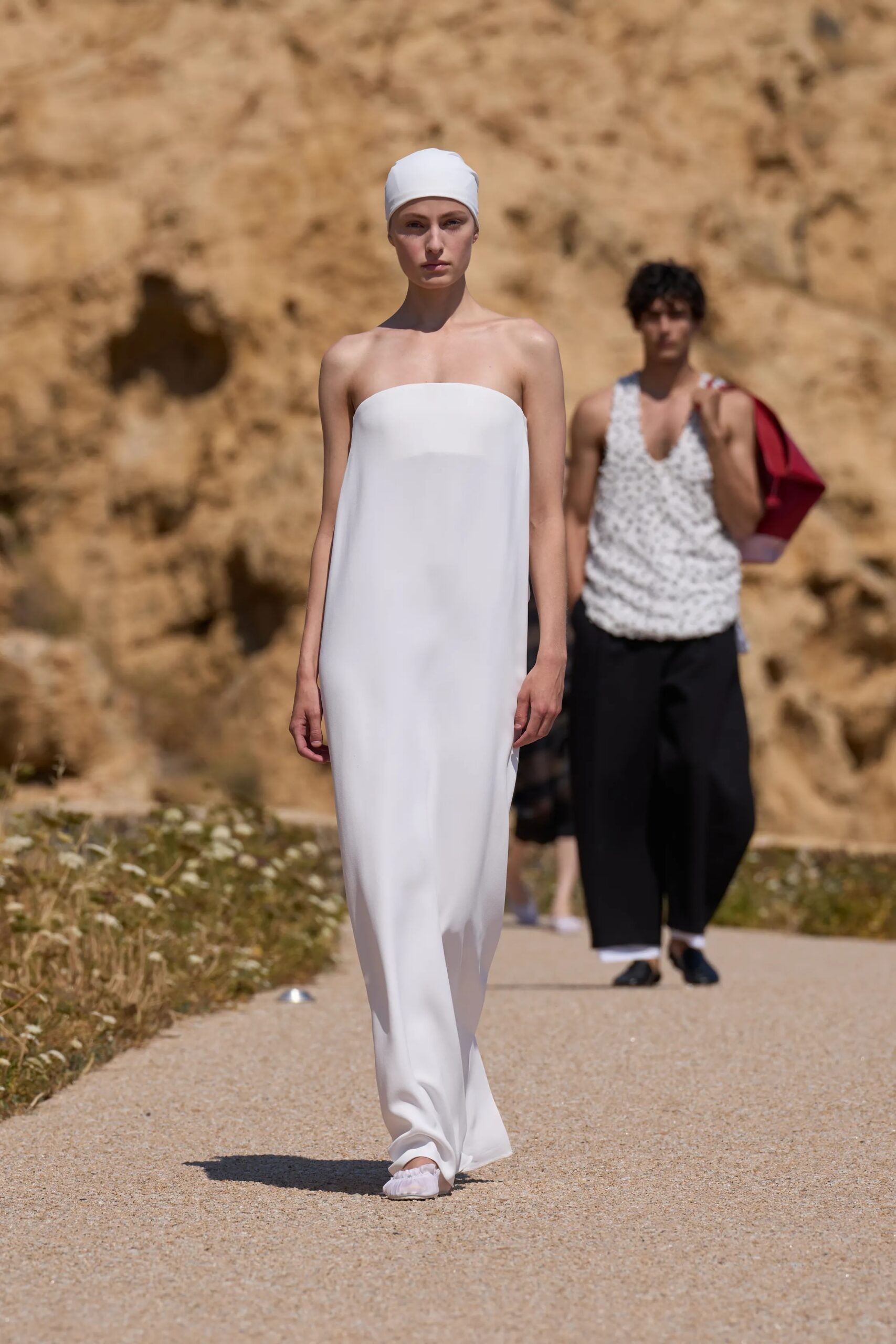Jacquemus Spring Summer 2027 strapless white column dress styled with matching headscarf.