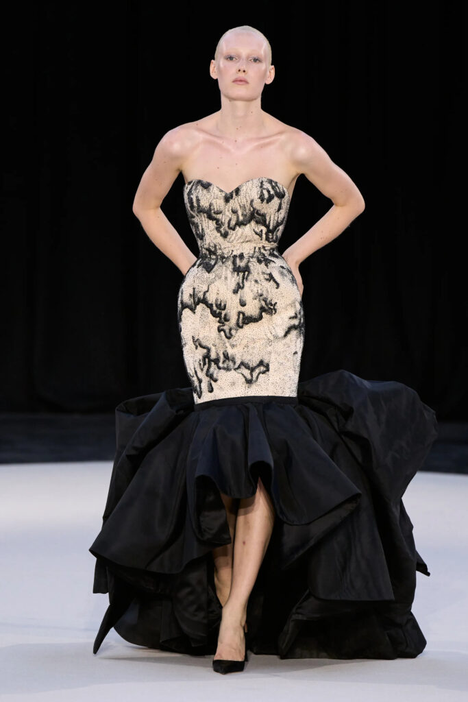 A sculpted silver corset meets a sweeping black train in one of Ashi Studio’s defining couture statements