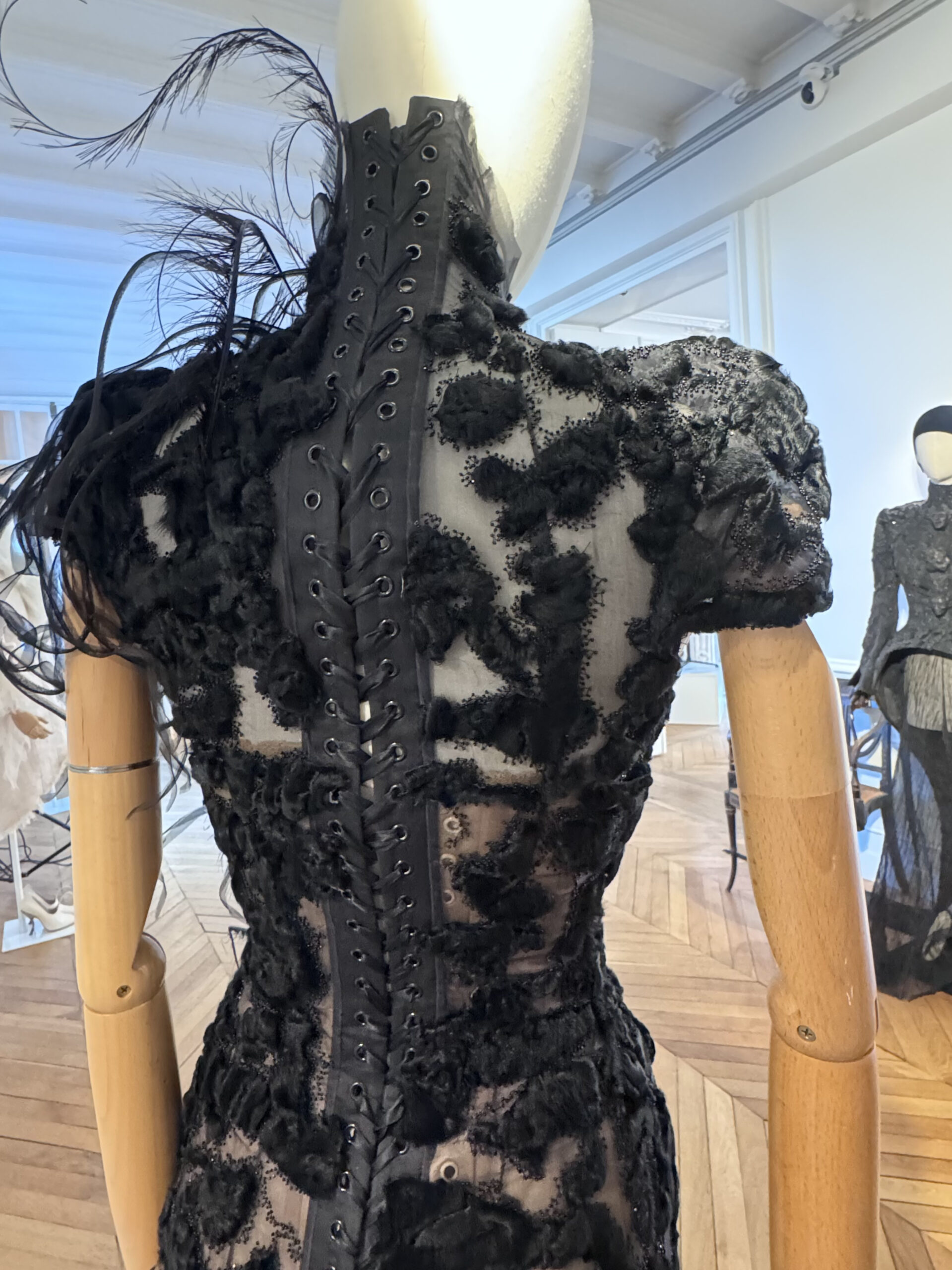 Back view of a black Ashi Studio couture gown highlighting construction and craftsmanship during the presentation