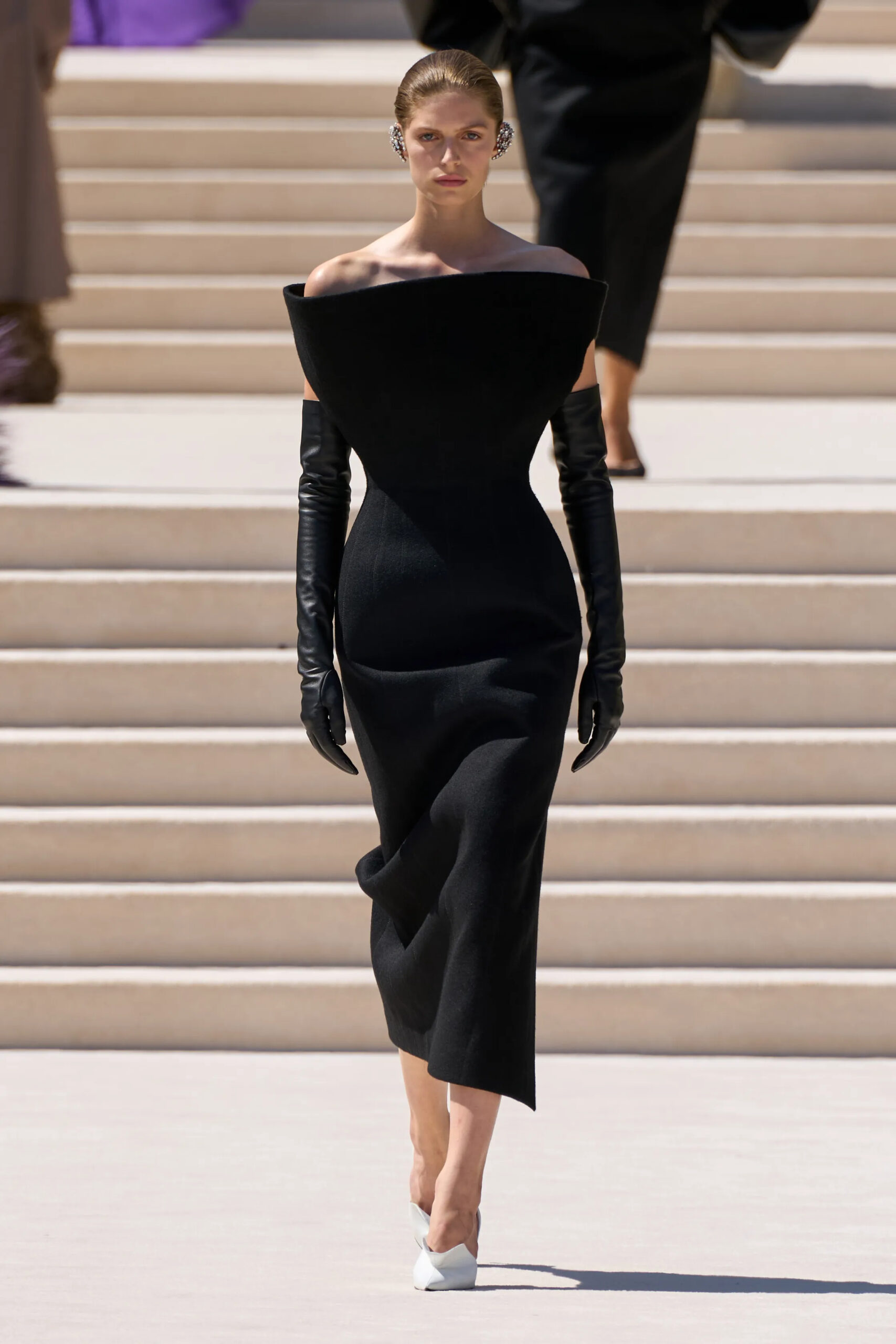 Model wearing a sculpted black off-the-shoulder Balenciaga Fall 2026 Couture dress by Pierpaolo Piccioli