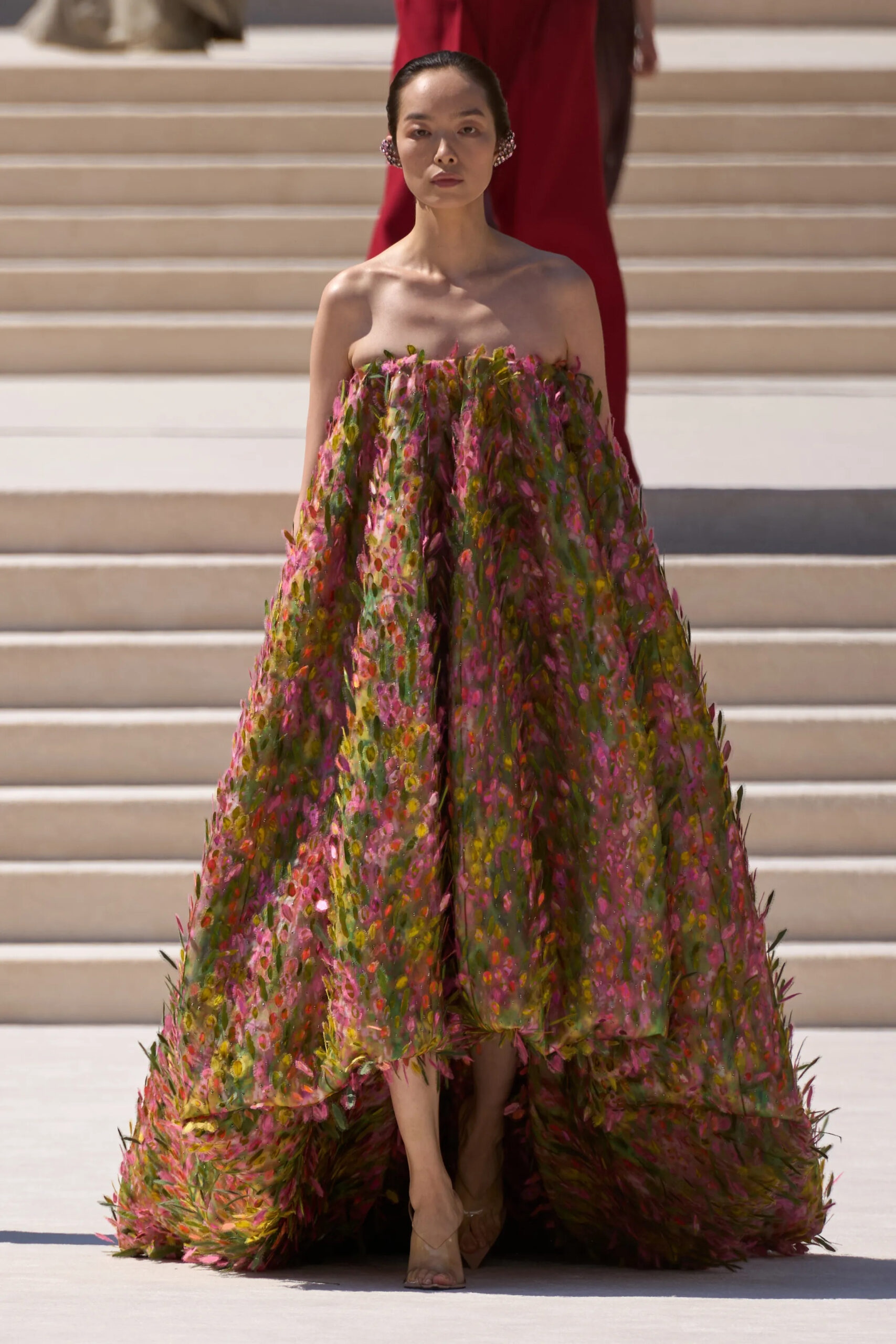 Model wearing a strapless floral embroidered Balenciaga Fall 2026 Couture gown featuring painterly botanical embellishments, dramatic volume, and a sweeping train by Pierpaolo Piccioli