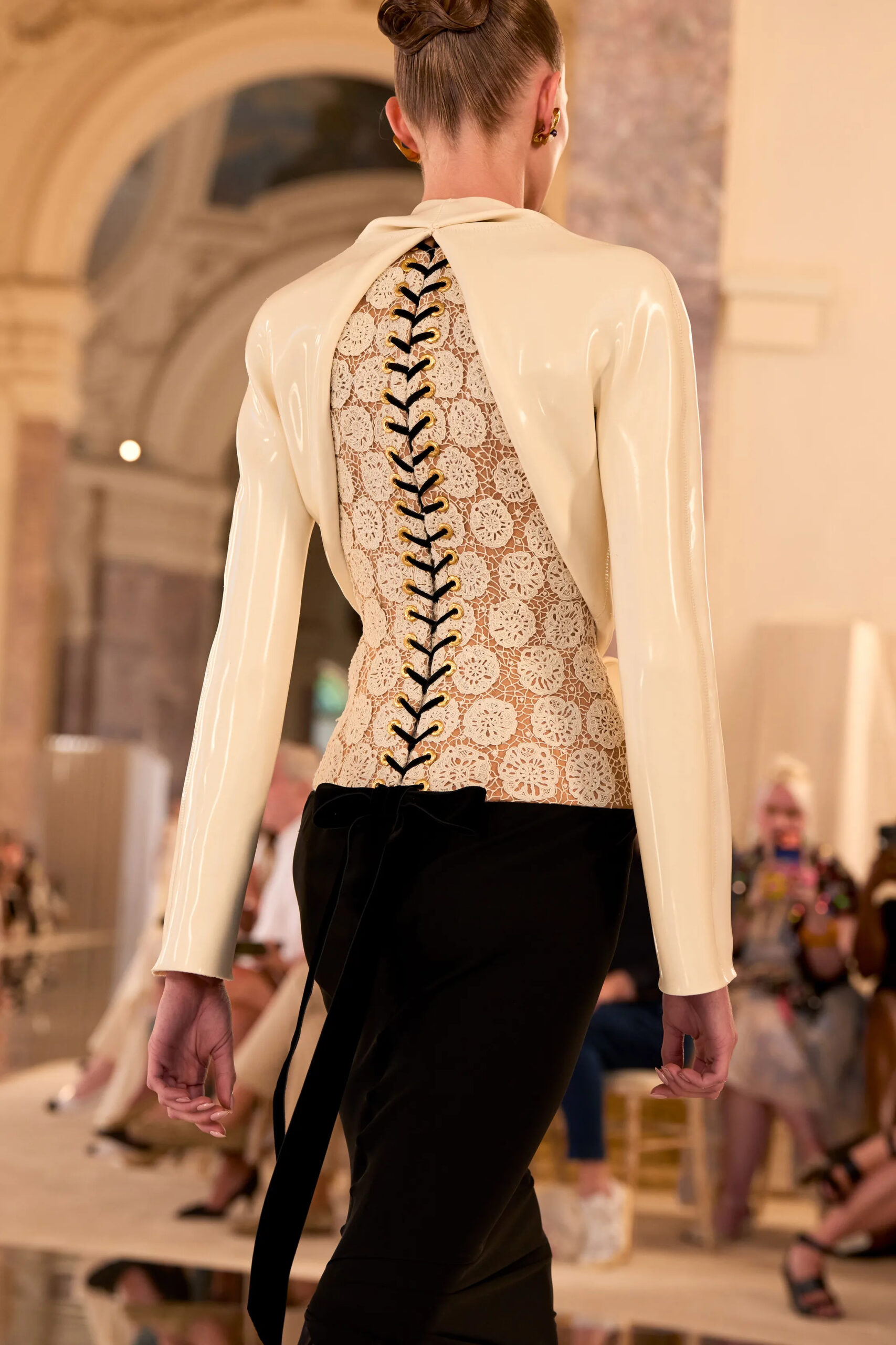 Close-up of a lace-up corset back with gold eyelets from the Schiaparelli Fall 2026 Couture collection by Daniel Roseberry
