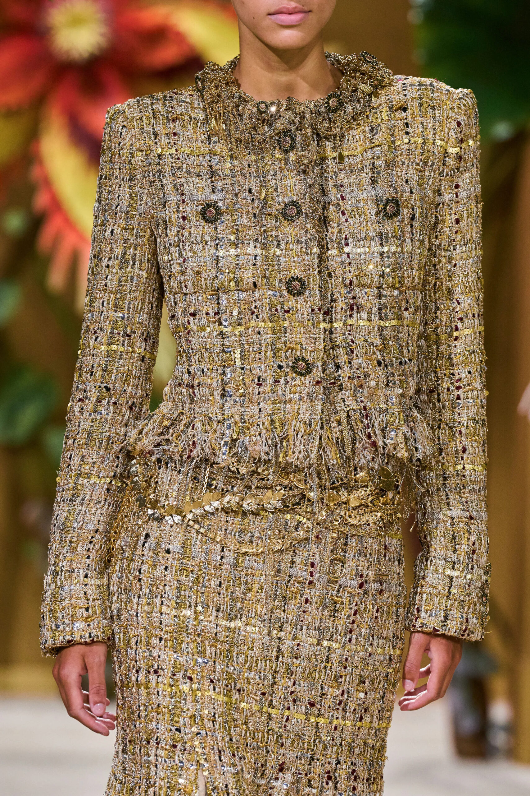Close-up of a gold tweed Chanel Fall 2026 Couture jacket highlighting intricate woven texture and refined tailoring
