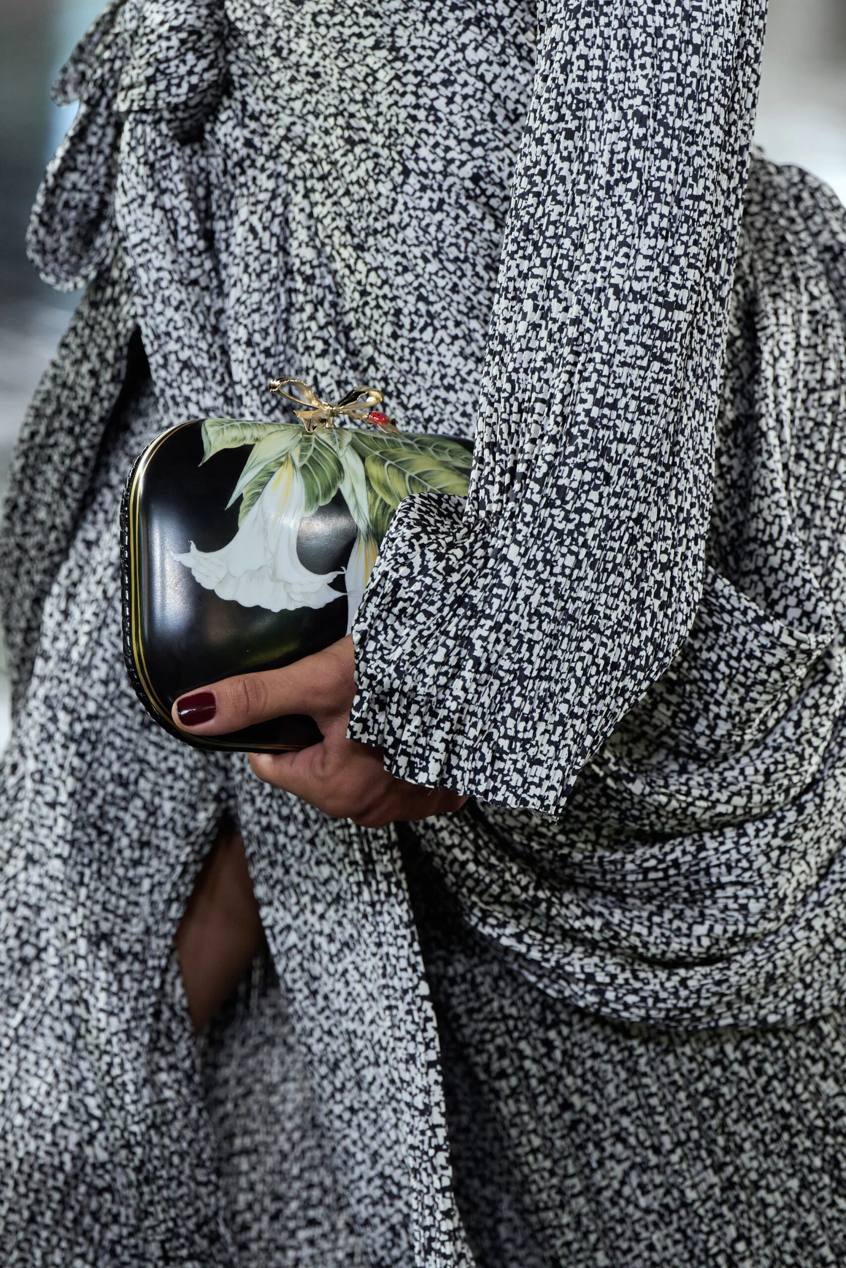 Black Dior couture evening clutch decorated with a large white floral motif