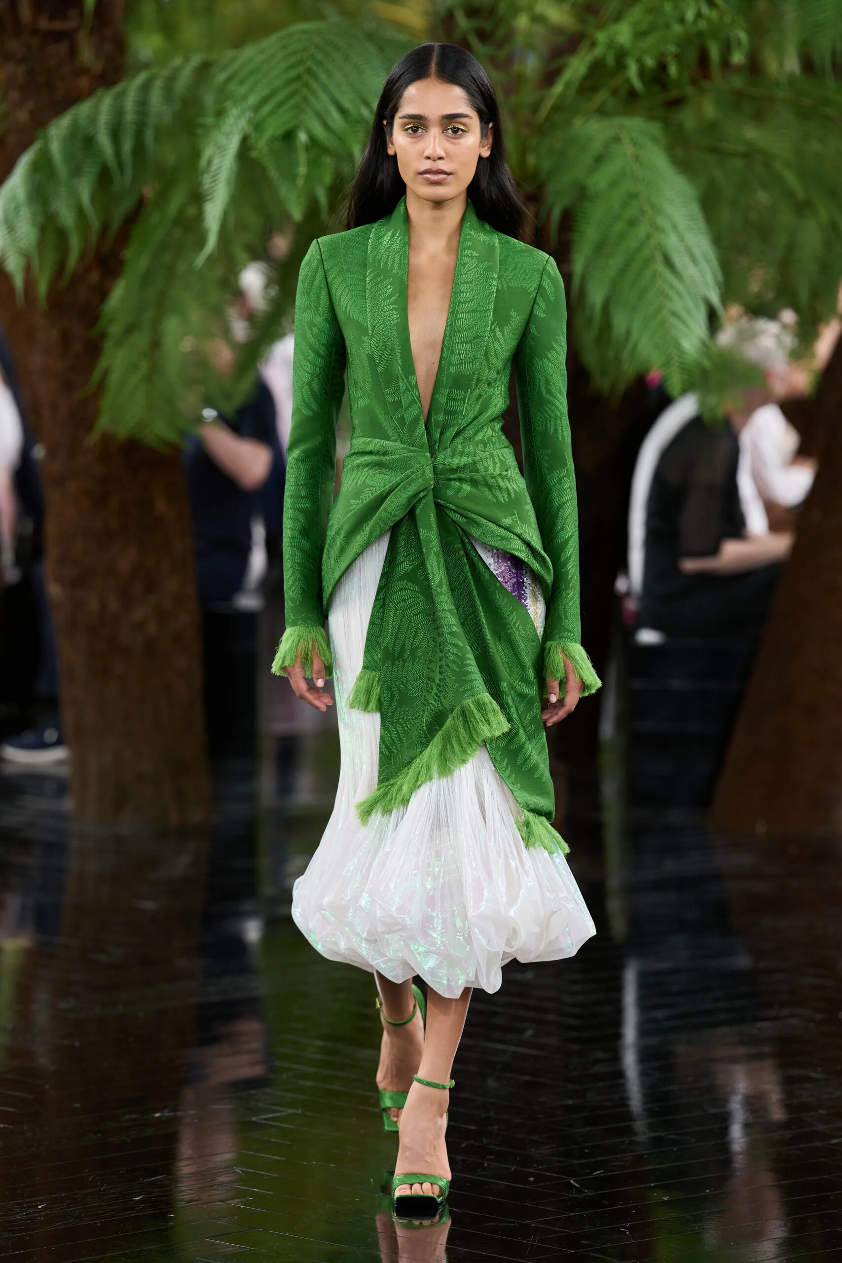 Model wearing a green jacquard Dior Fall 2026 Couture jacket over a white sculptural skirt