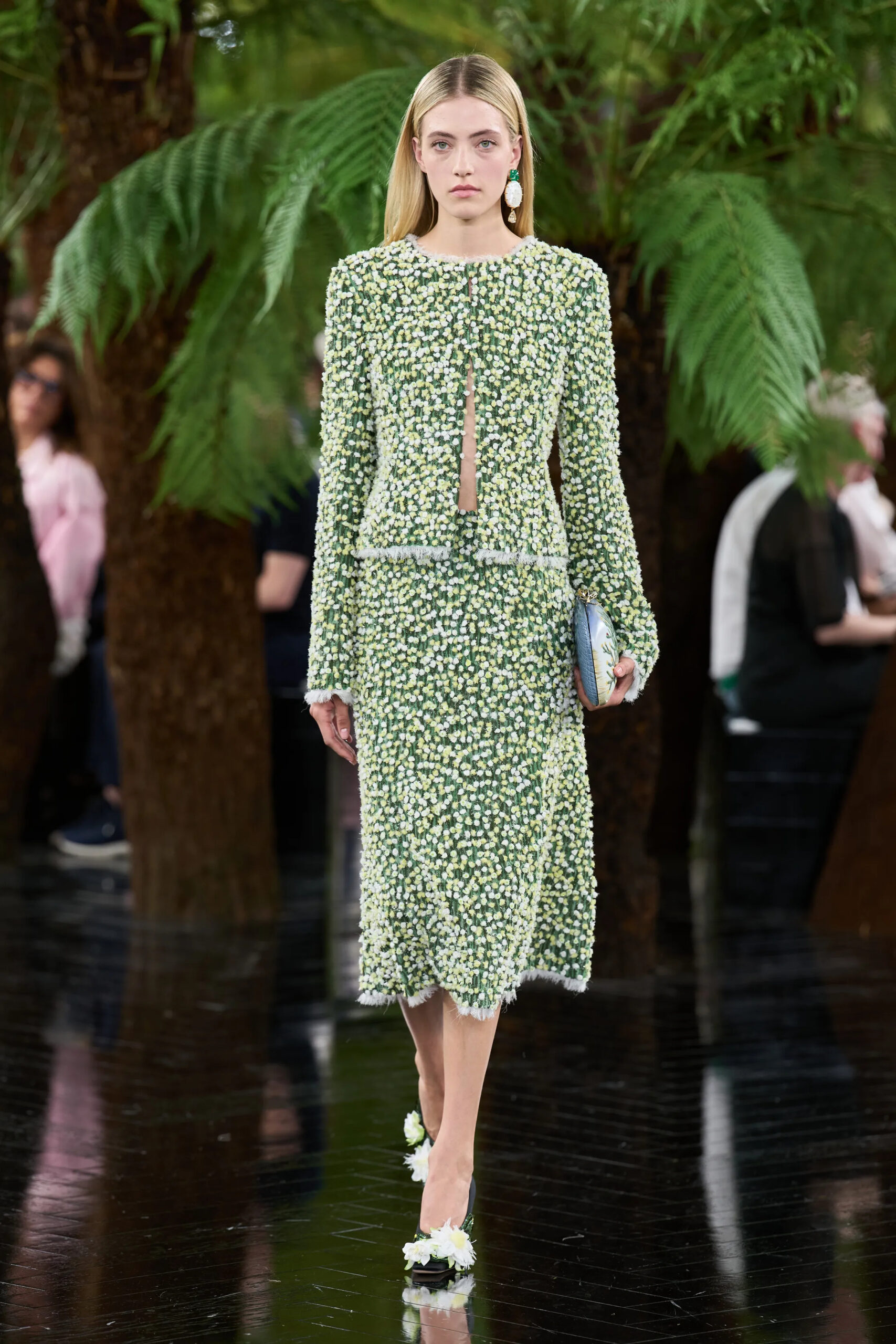 Model wearing a fully embroidered green and white floral Dior Fall 2026 Couture dress with coordinating floral accessories