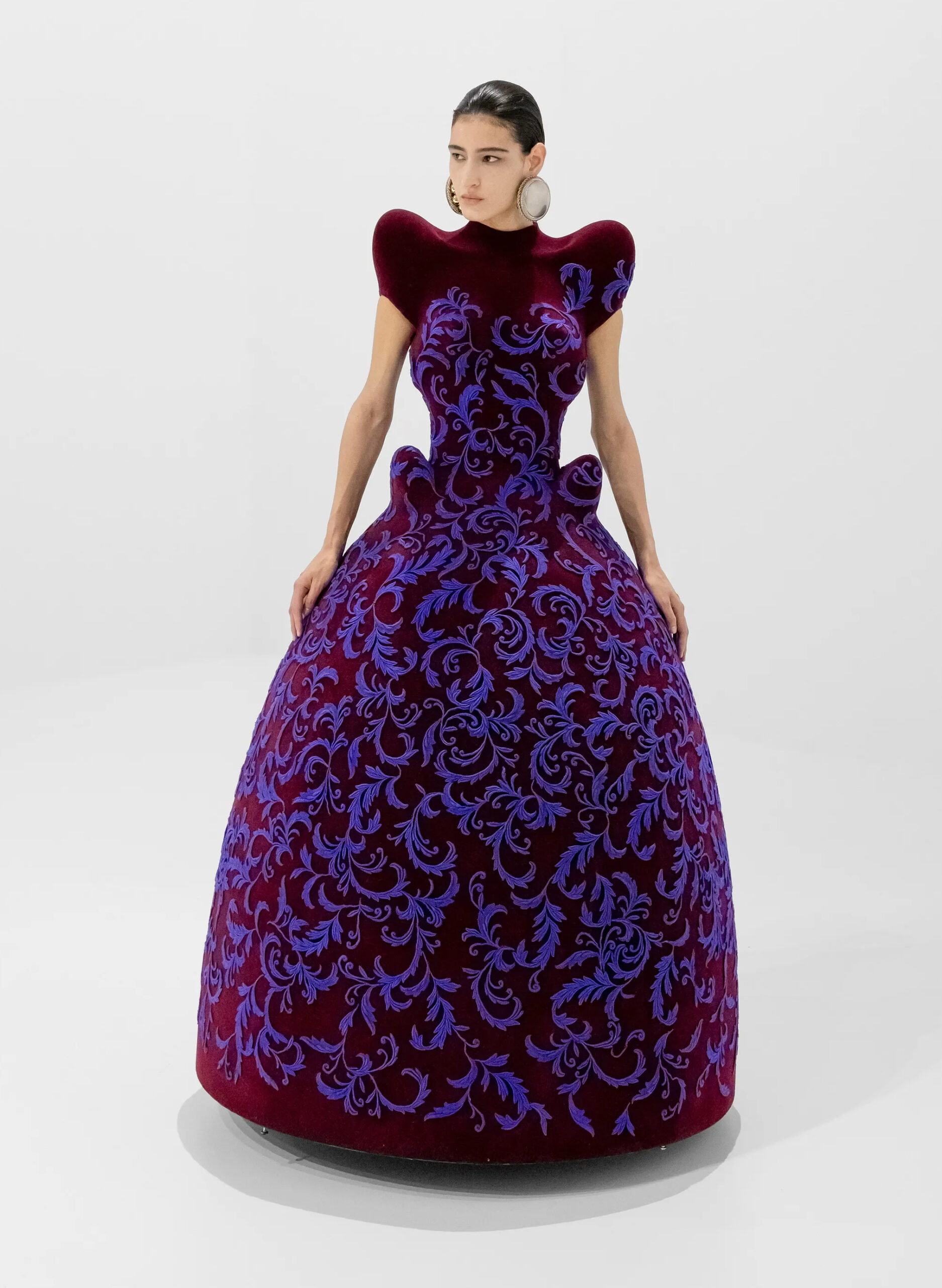 Burgundy sculptural ball gown with blue velvet motif from Jean Paul Gaultier Fall 2026 Couture