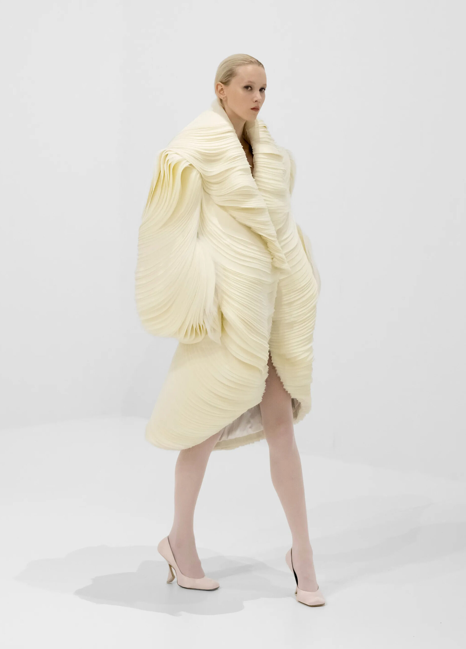 Ivory sculptural pleated couture coat from Jean Paul Gaultier Fall 2026 Couture