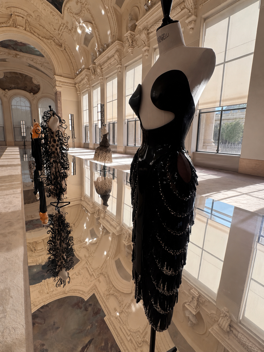 Black sculptural Schiaparelli couture dress displayed during the Fall Winter 2026–2027 private presentation at the Petit Palais