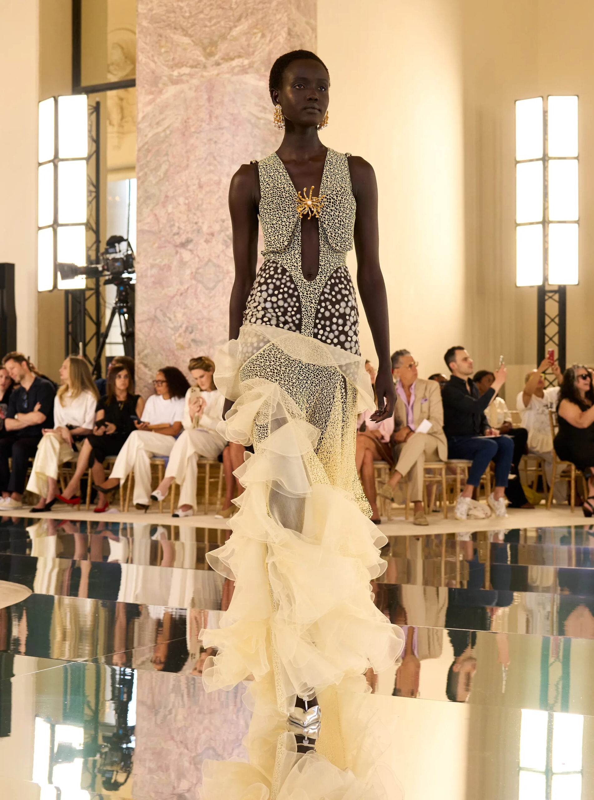 Ivory Schiaparelli couture dress featuring dramatic layered organza ruffles and surrealist embellishment.