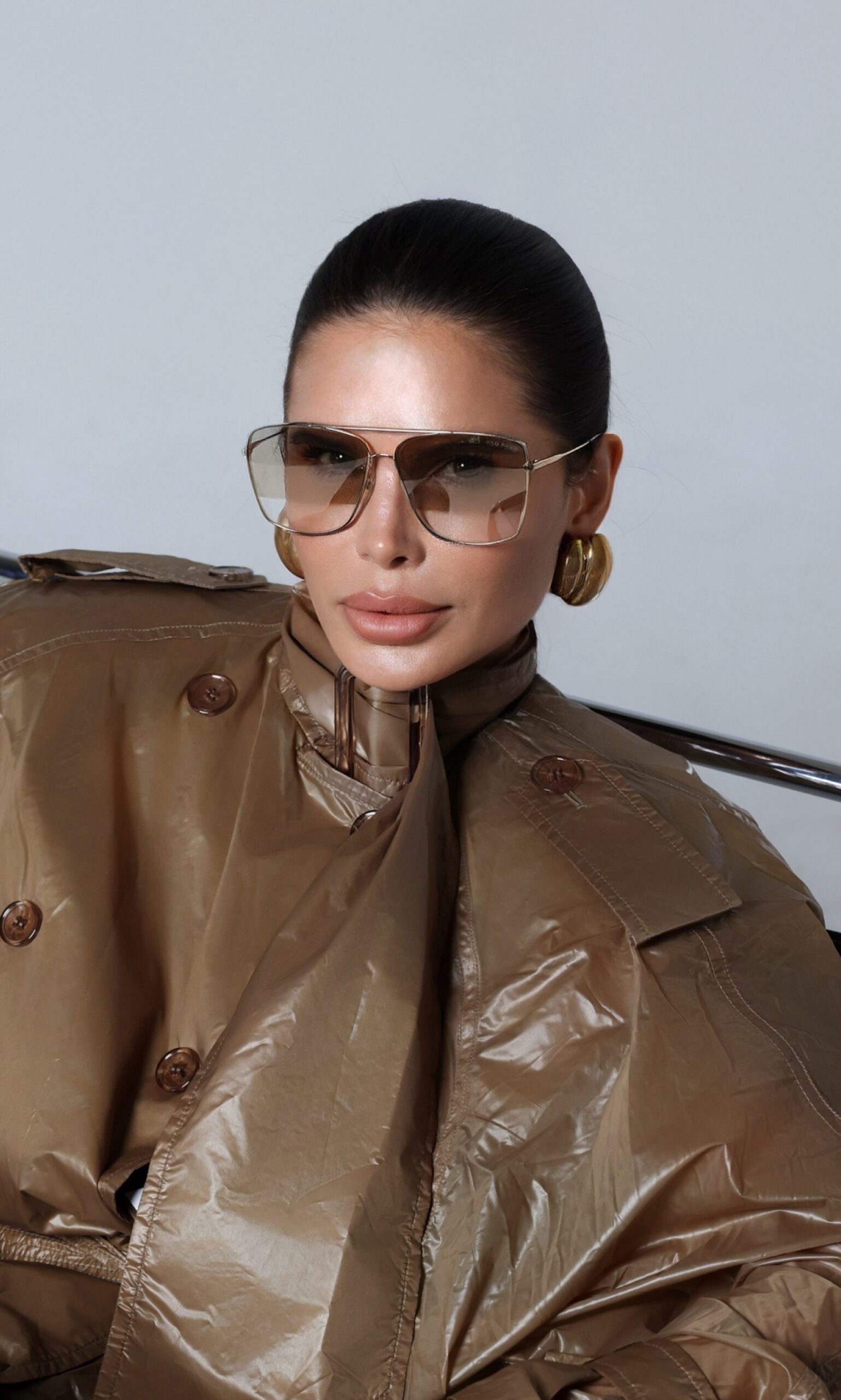 Close-up editorial portrait of Victoria Barbara wearing Saint Laurent with oversized sunglasses, gold earrings, and minimalist luxury styling